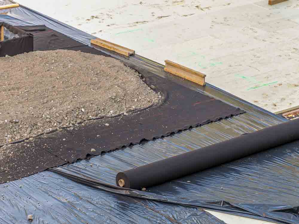 Installing geotextile fabric along a pathway